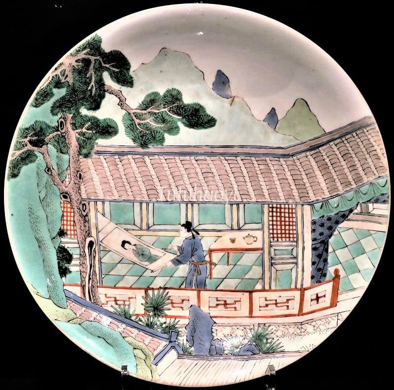 man looking at painting of a girl Peony Pavilion Kangxi porcelain dish
